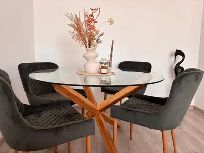 a dining room table with chairs and a vase on it at Apartamento Violette OLD Town Plovdiv in Plovdiv