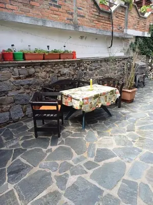 a table and two chairs on a stone patio at Студио в близост до църквата и центъра на града in Bansko