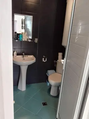 a bathroom with a sink and a toilet at Студио в близост до църквата и центъра на града in Bansko