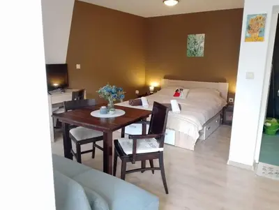 a bedroom with a bed and a table and a bed at Студио в близост до църквата и центъра на града in Bansko