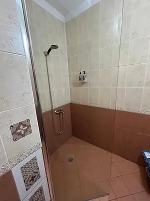 a shower with a glass door in a bathroom at Nice, Spacious and Cozy Apartment in Sofia
