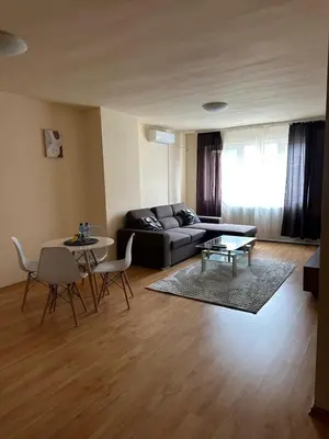 a living room with a couch and a table at Nice, Spacious and Cozy Apartment in Sofia