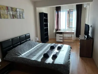 a bedroom with a bed with two slippers on it at Nice, Spacious and Cozy Apartment in Sofia