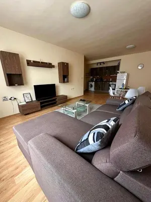 a living room with a couch and a television at Nice, Spacious and Cozy Apartment in Sofia