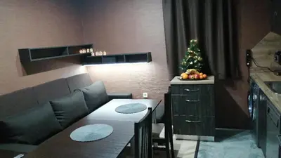 a living room with a christmas tree and a couch at Апартамент за гости в Пампорово in Pamporovo