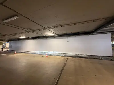 an empty parking garage with a large white wall at Demo apartment 1 in Sofia