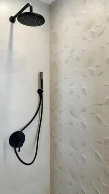 a shower with a black light on a wall at High End Elegant Living & Free Parking in Sofia