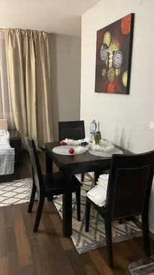 a dining room with a black table and chairs at Florimont Heights Apart Complex in Bansko