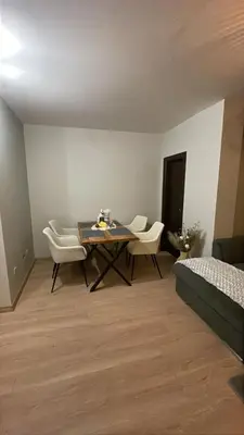 a room with a table and chairs and a bed at Florimont Heights Apart Complex in Bansko
