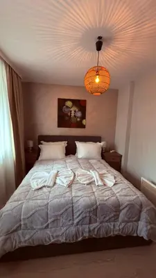 a bedroom with a bed with towels on it at Florimont Heights Apart Complex in Bansko