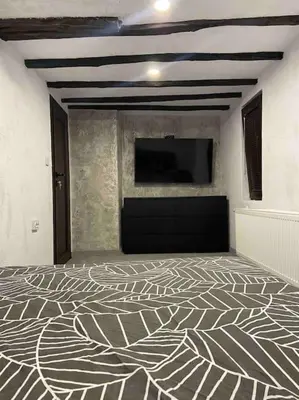 a room with a wall with a tv and a floor at Forest Hill in Troyan