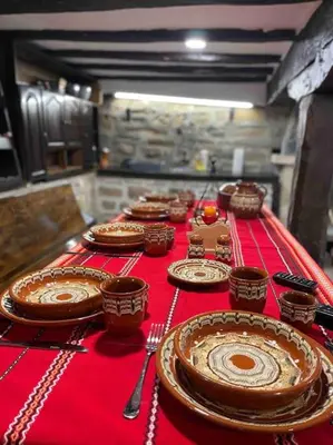 a group of plates on a red table at Forest Hill in Troyan