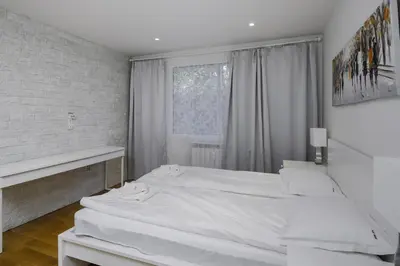 a white bedroom with two beds and a window at Bright & Cozy 1BD Apartment close to South Park by Flat Mаnager in Sofia