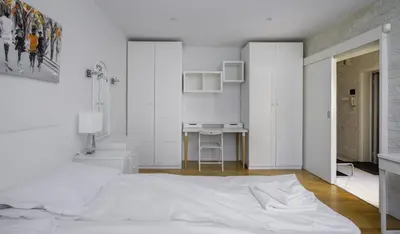a white bedroom with a bed and a desk at Bright & Cozy 1BD Apartment close to South Park by Flat Mаnager in Sofia