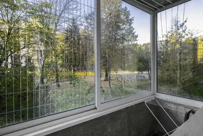 a room with windows looking out at a park at Bright & Cozy 1BD Apartment close to South Park by Flat Mаnager in Sofia