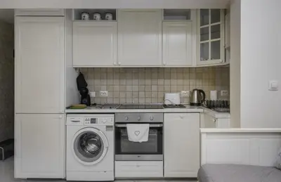 a kitchen with white cabinets and a washing machine at Bright & Cozy 1BD Apartment close to South Park by Flat Mаnager in Sofia