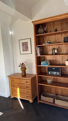 a room with a book shelf with a wooden dresser at Stylish Two Bedroom Family Villa in Sopot