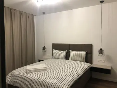 a bedroom with a bed with two towels on it at Stylish 2BDR apartment Gramada, free parking in Sofia