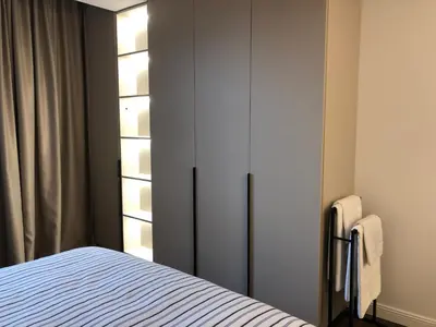 a bedroom with a bed and a closet at Stylish 2BDR apartment Gramada, free parking in Sofia
