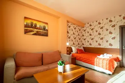 a living room with a couch and a bed at Chalet Bizet cosy home in BANSKO in Bansko