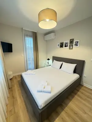 a bedroom with a large white bed with a light at Grandma Anni's House in Plovdiv