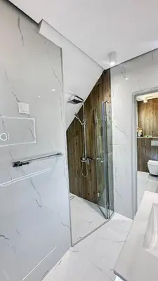 a white bathroom with a shower and a sink at Grandma Anni's House in Plovdiv