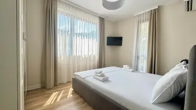 a bedroom with a large bed and a large window at Grandma Anni's House in Plovdiv