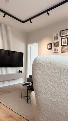 a living room with a couch and a flat screen tv at Grandma Anni's House in Plovdiv