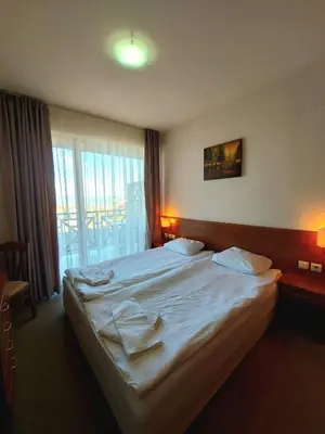 a bedroom with a large white bed with a window at Vihren Palace Residence, close to Gondola lift,211 in Bansko