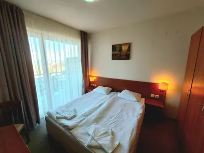 a bed in a hotel room with a window at Vihren Palace Residence, close to Gondola lift,211 in Bansko