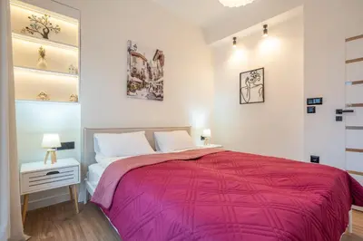 a bedroom with a bed with a pink blanket at Nova Nook in Sofia