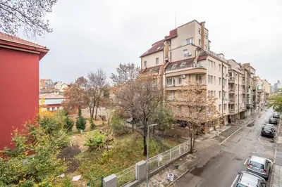 an apartment building on a city street with cars parked at Nova Nook in Sofia