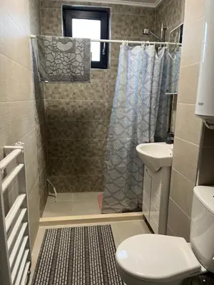 a bathroom with a shower and a toilet and a sink at PARK ESCAPE Holiday Home 24h check in in Sandanski