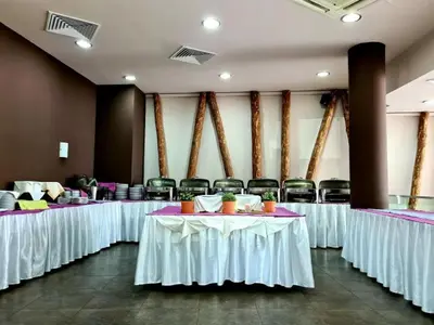 a row of tables in a room with chairs at Aspen Golf Apartment with Stunning Mountain View in Bansko