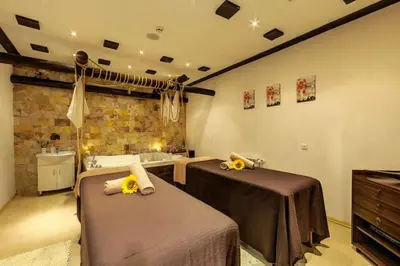 a bathroom with two beds and a sink and a tub at Apartment Dream Bansko- 5 min walk to Gondola in Blagoevgrad