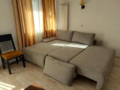 a bed in a room with a couch and a chair at Dream apart-hotel, duplex apartment in Bansko