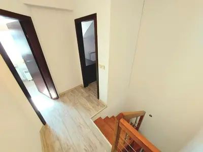 a hallway with a stairway leading to a mirror at Dream apart-hotel, duplex apartment in Bansko