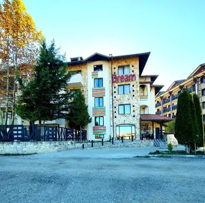 a large white building with a sign on it at Dream apart-hotel, duplex apartment in Bansko