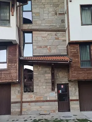 an exterior view of a building with windows at Apartment Melania in Complex Royal Towers in Bansko