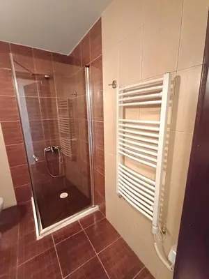 a bathroom with a shower with a glass door at Apartment Melania in Complex Royal Towers in Bansko