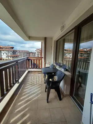 a balcony with a table and a view of a city at Apartment Melania in Complex Royal Towers in Bansko