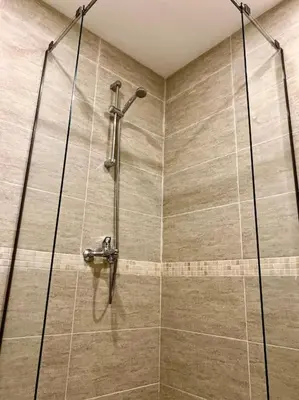 a shower in a bathroom with a glass door at Bright New Apartment With Parking At The Center! in Sofia