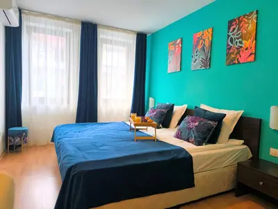 a bedroom with a large bed with blue walls at Botanique - Cozy stay with free Bottle of Wine in Bansko