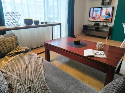 a living room with a coffee table and a tv at Botanique - Cozy stay with free Bottle of Wine in Bansko