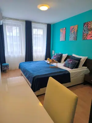 a bedroom with a bed and a blue wall at Botanique - Cozy stay with free Bottle of Wine in Bansko