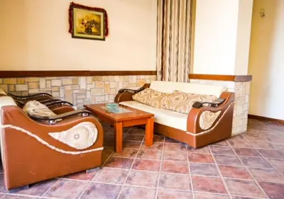 a living room with two couches and a table at Amber - Mountain Escape with free Bottle of good Wine in Bansko