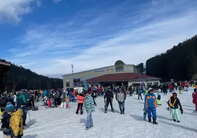 a crowd of people walking in the snow in front of a building at Amber - Mountain Escape with free Bottle of good Wine in Bansko