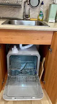 an open dishwasher in a kitchen under a sink at Mountain View, Grand Monastery Pamporovo, top location in Pamporovo