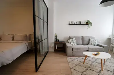a bedroom with a bed and a couch and a table at Urban Chic Sofia Top Central Location in Sofia