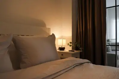 a bedroom with a bed with a lamp and a window at Urban Chic Sofia Top Central Location in Sofia